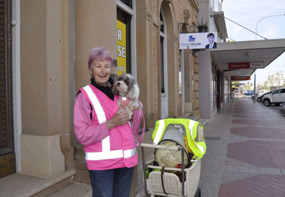 Adrienne Carpenter and four-year-old moodle dog, Phoebe, set off from Hume MP Angus Talyor's office for the 100km walk to Canberra on Monday morning. Photo: Louise Thrower.