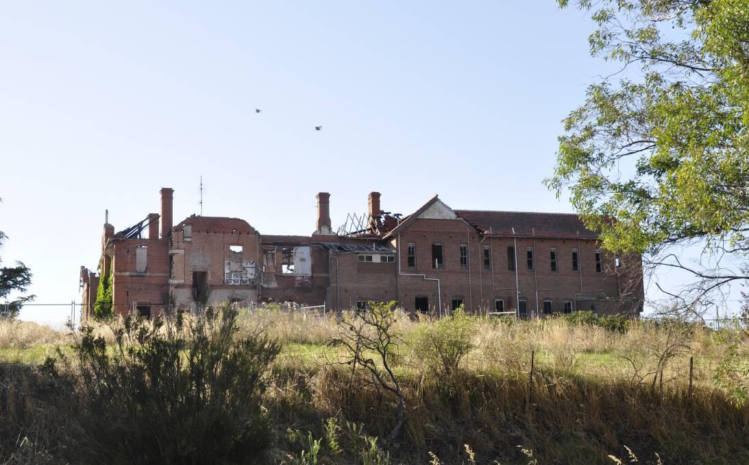 A small section of the St John's orphanage (at left) has been demolished in recent weeks. The council is mounting legal action over the owner's failure to demolish the entire structure by December 31, 2022. Picture by Louise Thrower.