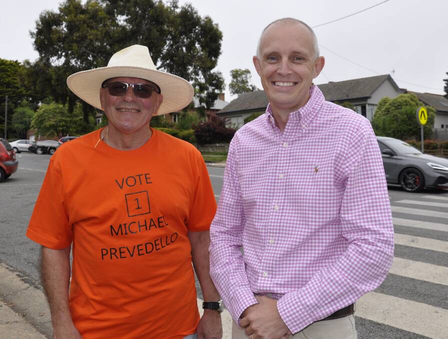 Independent candidates Michael Prevedello and Dan Strickland chatted at the Goulburn High School booth on Saturday morning. Photo: Louise Thrower