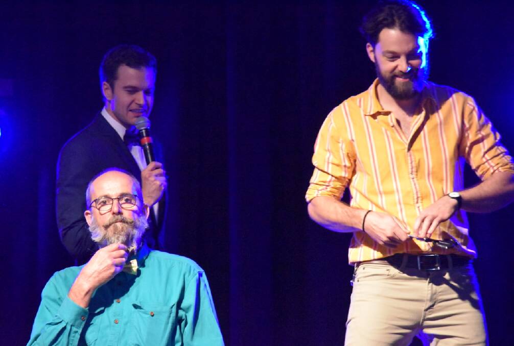 GREAT NIGHT: Magician and illusionist Jonas Jost (rear) had some fun on stage last year Drew Bissett (right) and his father, Warwick Bisset, who was poised for a fundraising beard shave. Photo: Dianna Bisset.