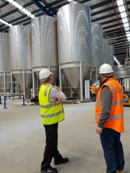 TOUR: Tribe Brewery operations manager Joerris Noll (right) shows Mayor Bob Kirk just some of the infrastructure in place at the Hume Street complex. Photo supplied.