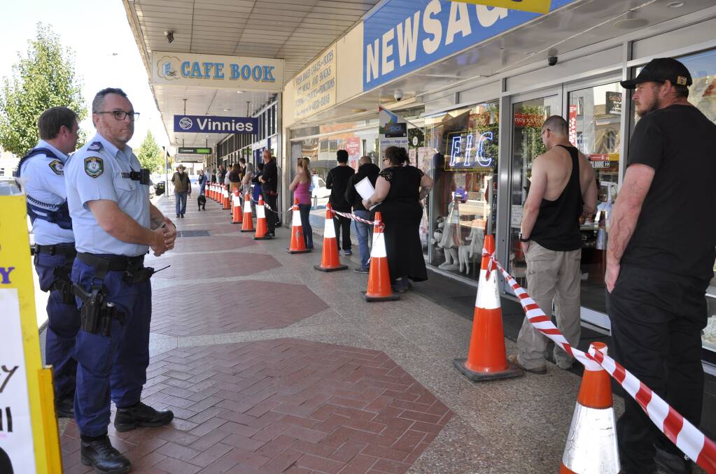 ON-SITE: Police helped maintain an orderly set-up as people lined up at Centrelink on Monday morning to access assistance. Photo: Louise Thrower.