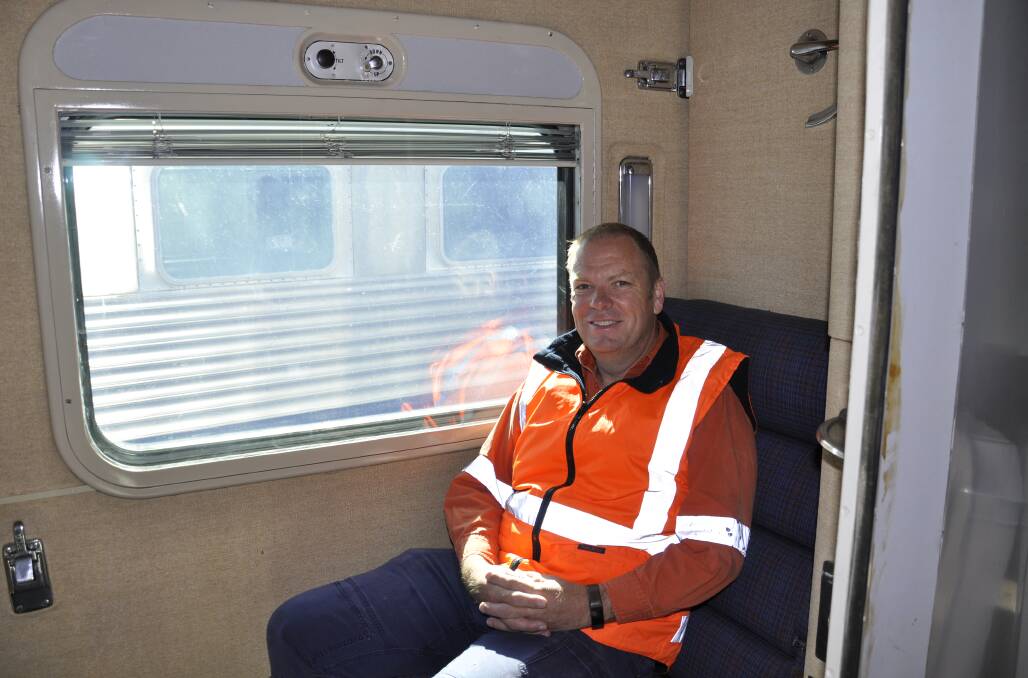 Simon Mitchell relaxing inside one of the passenger cabins. The seat folds back to become a bed at night.
