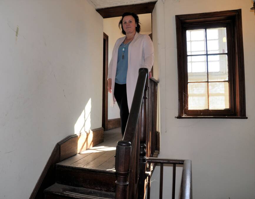 Ms Ruberto demonstrates two of the staircases posing access challenges. Rooms on the upper and lower levels may need to be closed off if a compromise with the office of Environment and Heritage isn't reached.