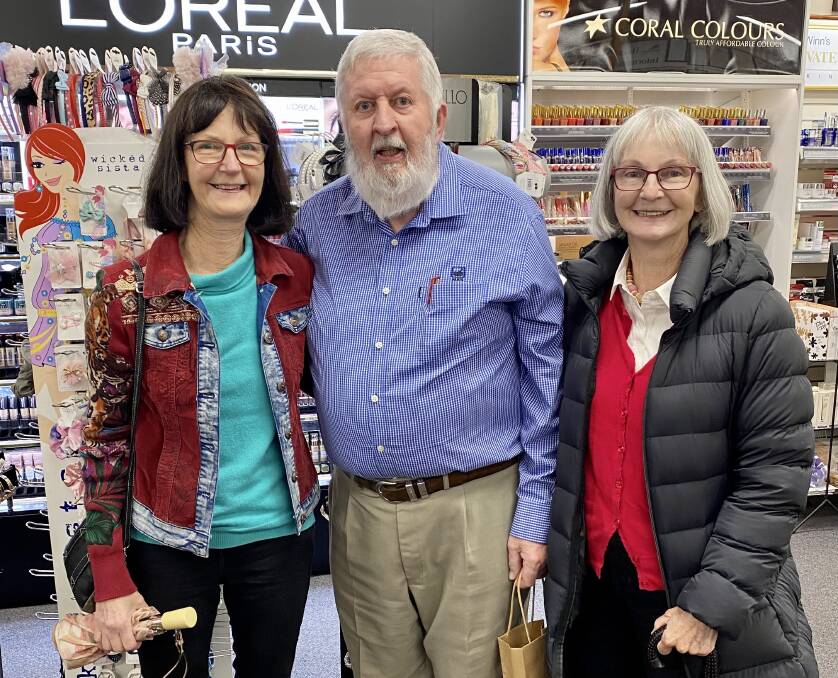 LIKE FAMILY: Margaret Hilly and Veronica Steep, daughters of the late Peter Hart who originally owned the pharmacy, made a special trip to help celebrate Mr Wicks' 50 years in business.