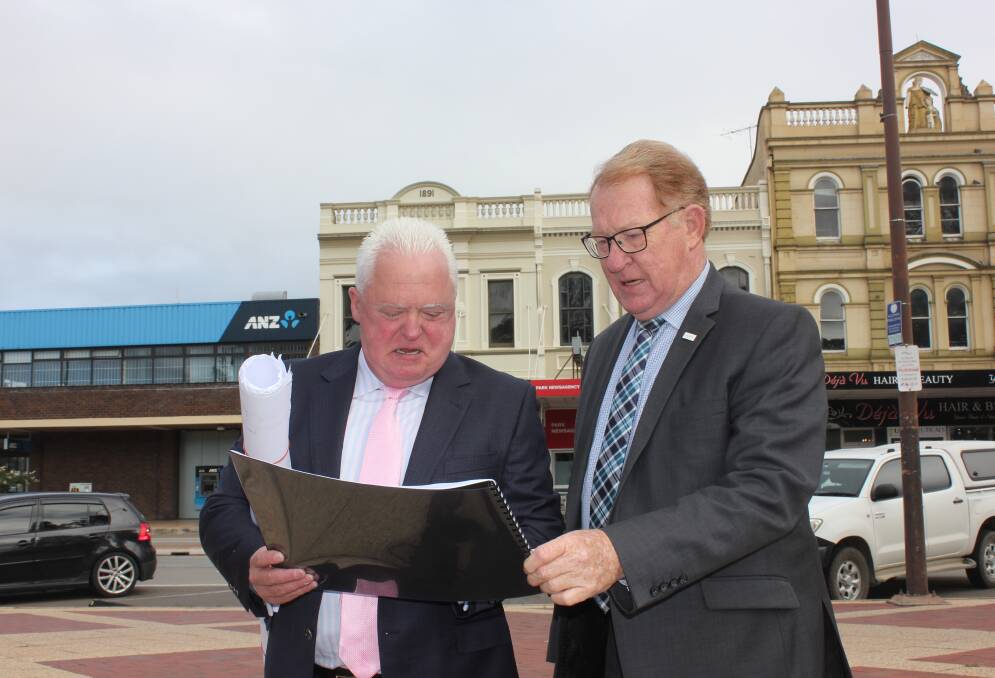 PROPOSAL: Signature Care CEO Graeme Croft and Mayor Bob Kirk viewed plans of the company's proposed aged care facility last year. Cr Kirk has argued the company shouldn't receive an infrastructure fee reduction. Photo: David Cole.
