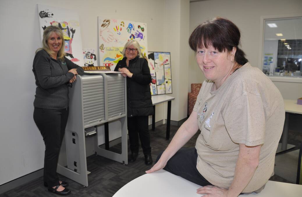 Katie Johansen says she's been missing Leisure Link programs at the Goulburn Community Centre since they were suspended in March. At rear is community services supervisor, Megan Short, and Katie's mother, Heather Johansen. Picture by Louise Thrower.