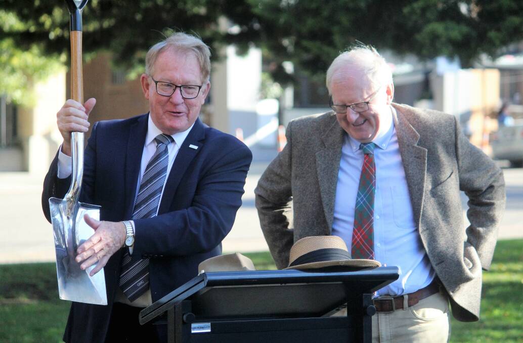 Mayor Bob Kirk shares a joke with Dennis Wilson, the NSW Governor's husband, before he planted an oak tree in Belmore Park, commemorating the 150th anniversary of rail in May 2019. 