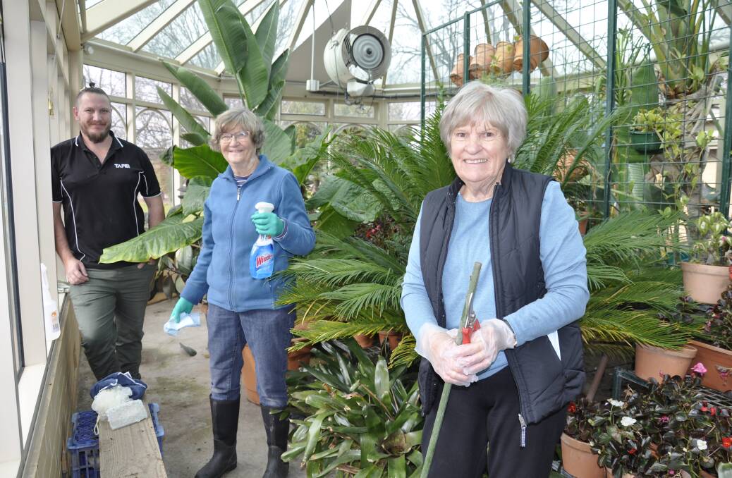 HANDS ON DECK: Illawarra TAFE Goulburn horticulture and landscape construction teacher, Tim Dally, and volunteers Heather West and Linda Cooper are helping to transform the Belmore Park glasshouse. Photo: Louise Thrower.
