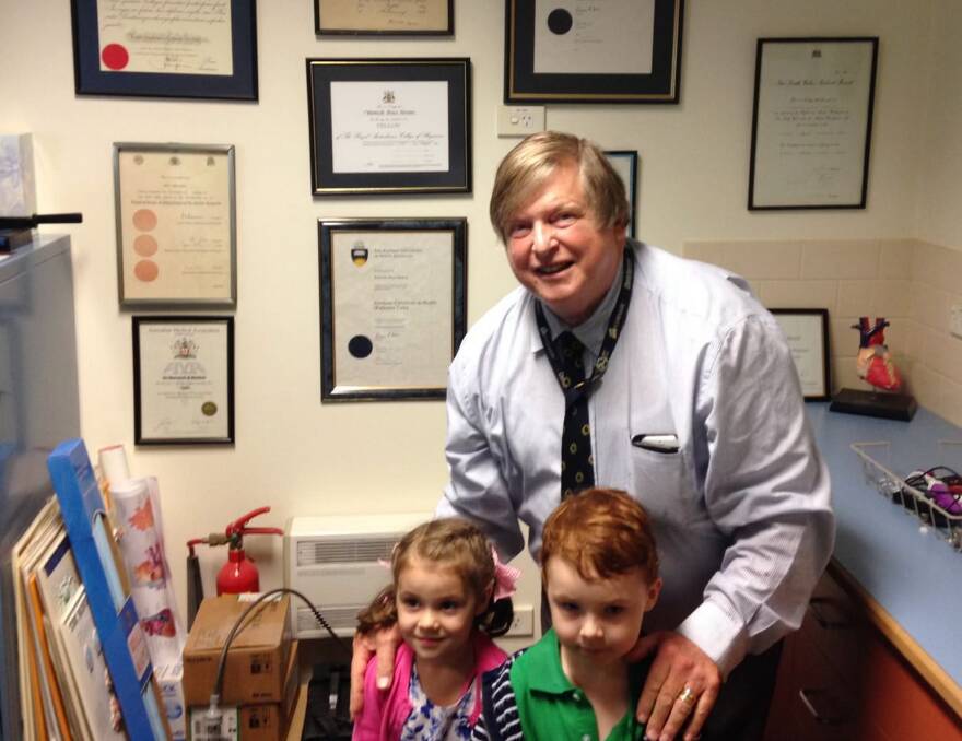 Dr Warwick Renton with grandchildren Oliver and Maya in his Goulburn clinic. Picture supplied.