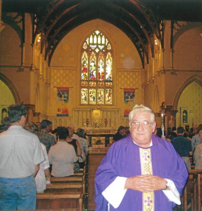 LOVED: Father Laurie Blake in his beloved Sts Peter and Paul's Cathedral in about 2003 when he stepped down as parish priest. Photo supplied.