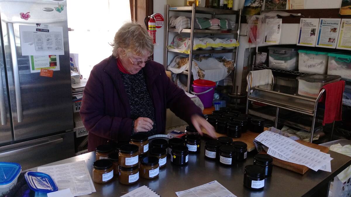 STOCKING UP: Chief "pot-stirrer" Dawn bottles the latest Riversdale grown produce for sale at the shop. Riversdale is located in Twynam Drive.