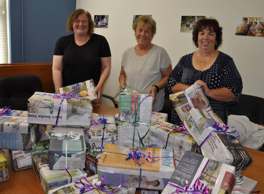 Mary Mead Family Referral Service staff Emma Perkins, Lana Gardiner and Michelle Redman were busy finalising the pamper packs on Thursday. Photo: Louise Thrower.