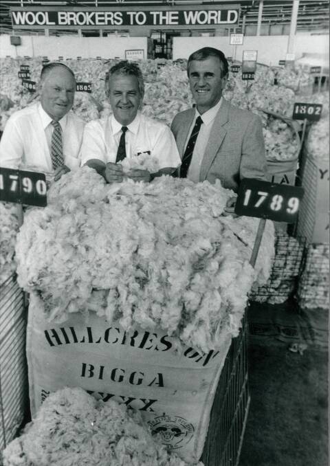 HOT PRICE: The late Trevor Picker (left) captured a seasonal record price of 110,000 cents/kg in March, 1992 for a 15.6 micron bale auctioned by Ray Moroney (right) and bought by Fujii Keora representative Ken Woodfull. Photo: Leon Oberg.