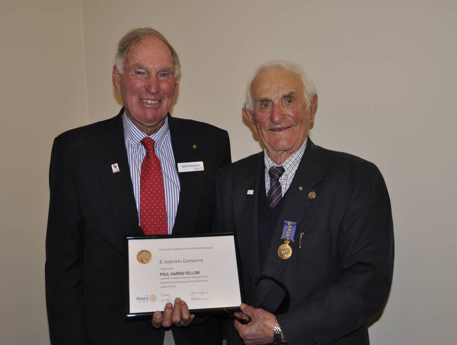 Rotary Club of Goulburn outgoing president, Geoff Henderson (left) presented Tony Lamarra with the prestigious Paul Harris Fellowship at a changeover dinner at the Workers Club on Monday night. Tony's wife, Adriana, is a co-recipient. Picture by Louise Thrower.