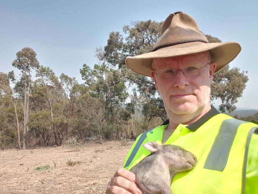 CARER: WIRES volunteer Urs Walterlin with a joey that died of heat exhaustion after surviving in a pouch following its mother's death from a car collision. Photo supplied.