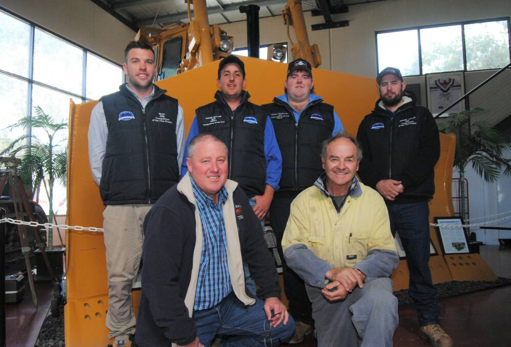 NSW Livestock, Bulk and Rural Carriers Association president Lynley Miners and member Fred Troutman (front) with Young Driver Award finalists and winners Riley Topping, 'Reggie' Sutton, Jeremy Taylor and Steven Richardson at the promotional shoot at Divall's on Wednesday. Photo: Louise Thrower.