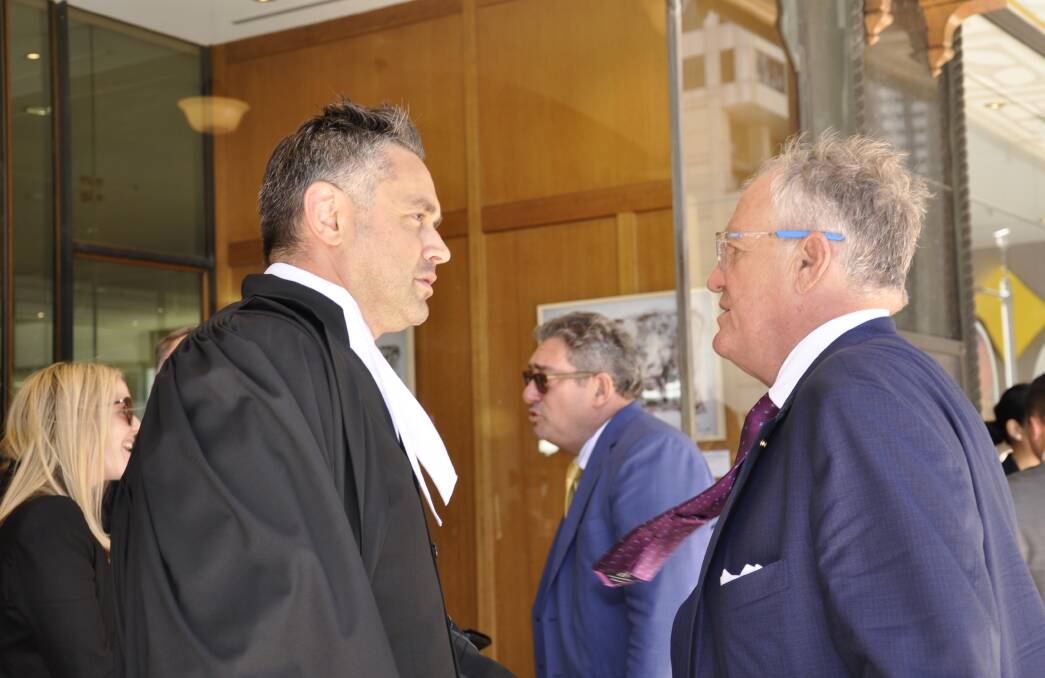 Crown prosecutor Tarik Abdulhak talks with Lennox's solicitor Greg Walsh outside Sydney's Downing Centre on Friday. Photo: Louise Thrower.