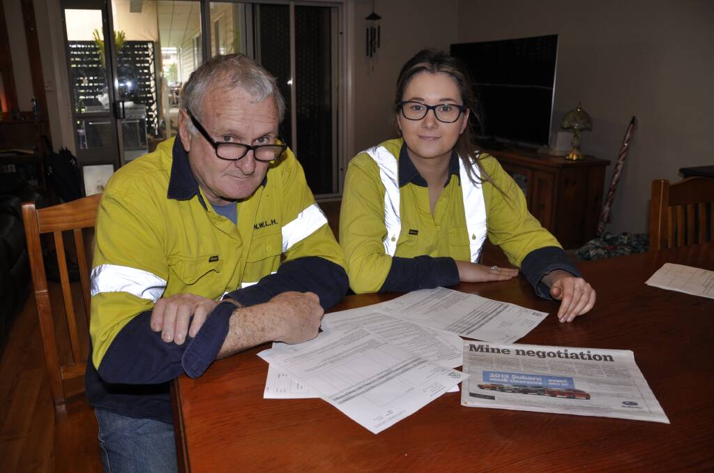 WAITING: Fred Speer and Sarah Chinnery peruse copies of invoices sent to Heron Resources that they say remain unpaid. Photo: Louise Thrower.