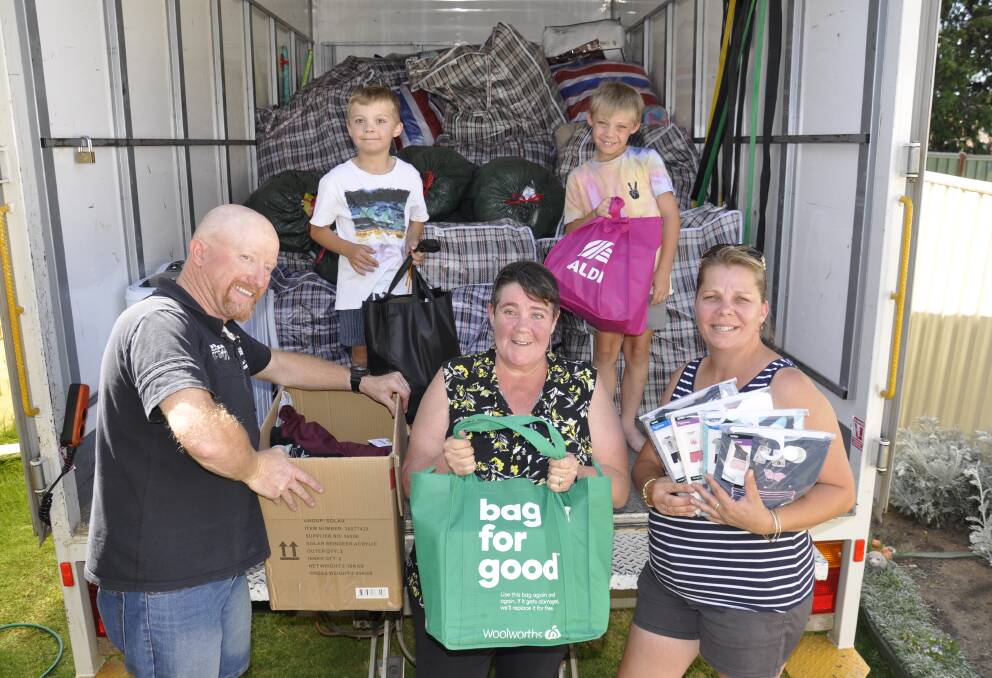 On a mission: Kylie Stone (right) with twin sons Ben and Toby, and friends Mick and Sharon Apps packed up the donations on Thursday ready for the trip. Photo: Louise Thrower.