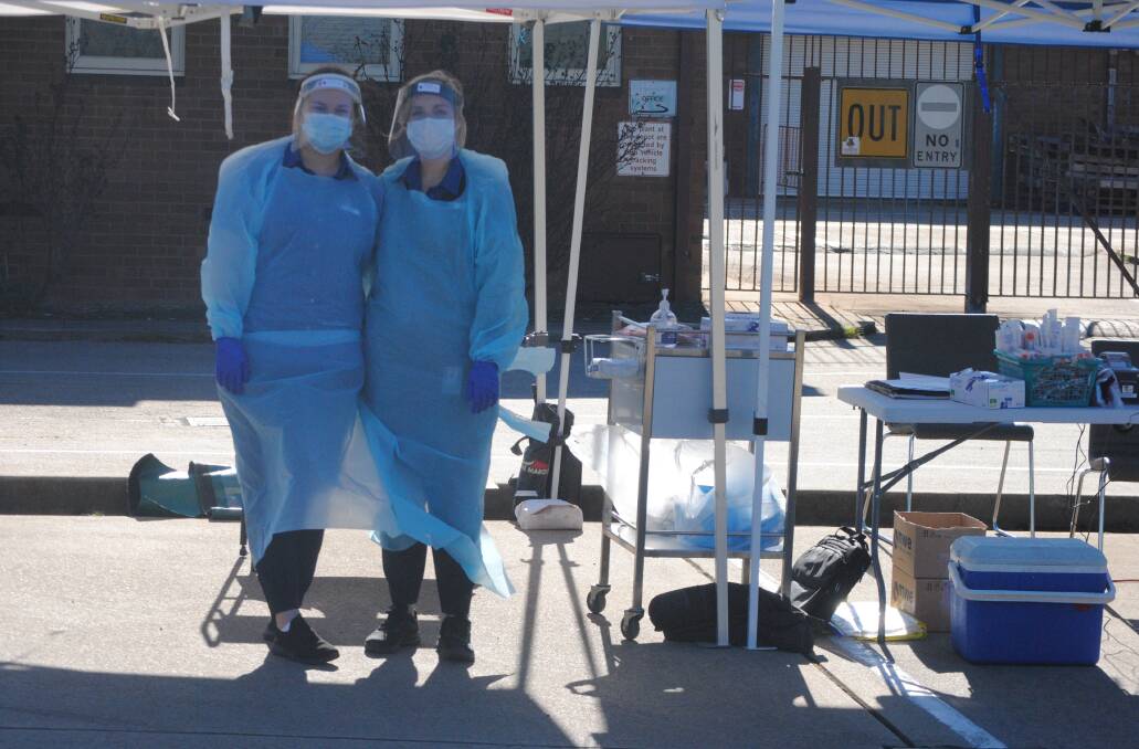 ON DUTY: Emma McDonald and Chloe Meagher conducted testing for Capital Pathology at the specially set up testing clinic at the former Bourke Street council depot. Photo: Burney Wong.
