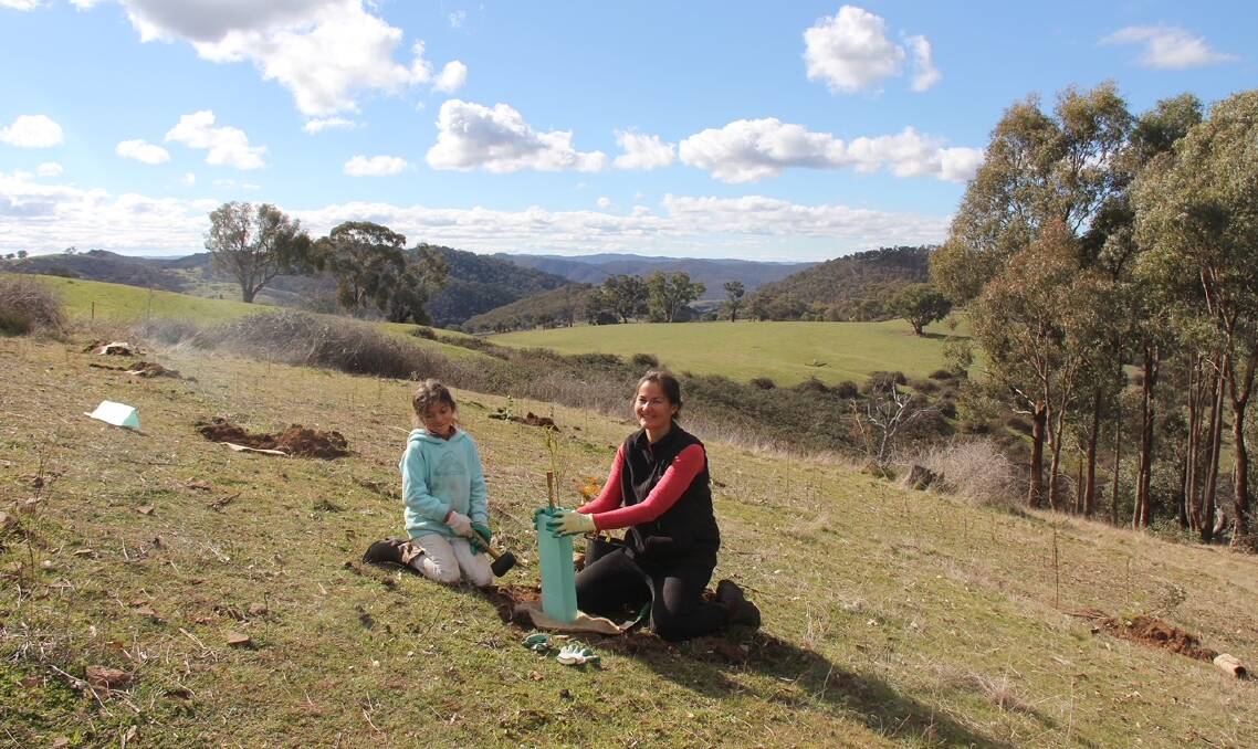 Mary Bonet and her daughter Gigi planting trees together on another project. Photo supplied. 
