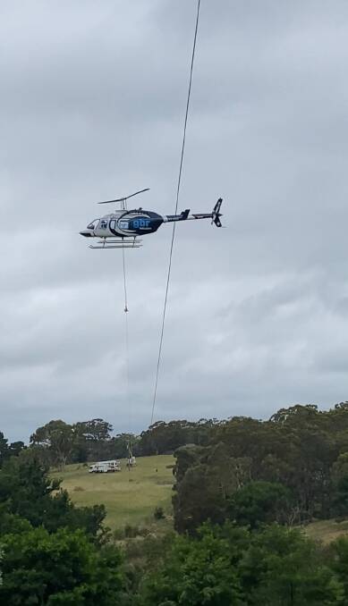 Essential Energy brought in a helicopter crew to identify and repair damaged powerlines over the weekend. One had dropped into the Wollondilly River. Photo: Essential Energy.