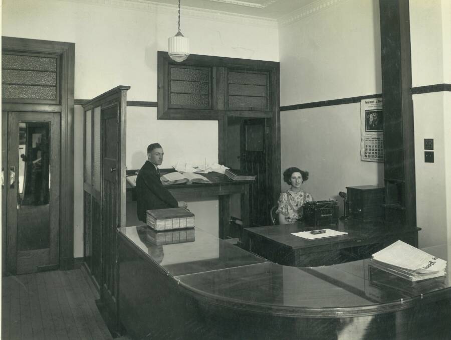 REFURBISHED: Book-keeper Lionel Harvey and receptionist Loris Pauley pictured in the Goulburn Evening Penny Post's newly refurbished building in 1935. Photo: Watt Telfer.