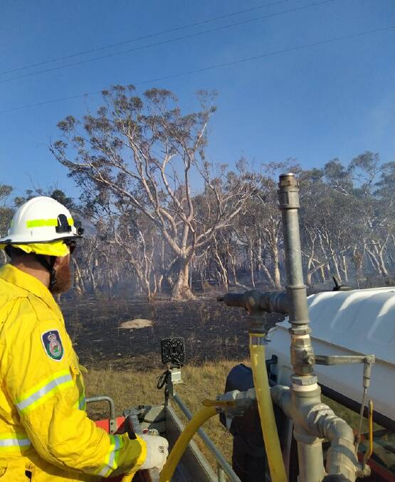 A Bungonia RFS brigade volunteer fighting the Jerrara Road fire near Marulan on Friday. Extreme fire conditions will apply on Wednesday. Picture supplied.