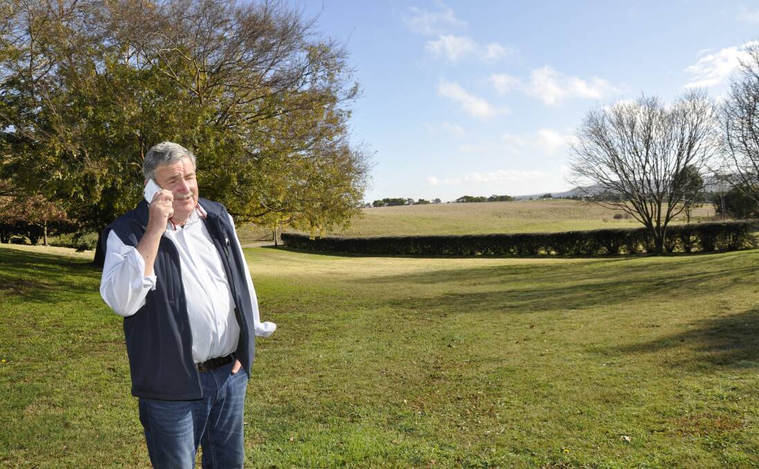 Stewart Thompson has to go outside his home on Goulburn's western outskirts to make calls and send emails on his mobile. Photo: Louise Thrower. 