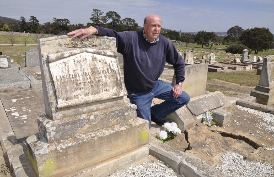 IN MEMORY: Retired engine driver David Stevenson at the Goulburn Lawn Cemetery graves of Lancelot Herrmann and Alfred Taylor. Bronze plaques will be fixed to the graves next month for the railwaymen who were killed in 1920. Photo: Louise Thrower. 