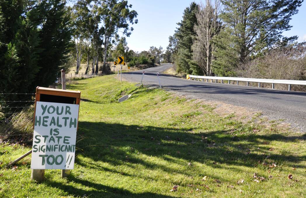 Jerrara Road is sprinkled with signs opposing the planned waste to energy plant. Photo: Louise Thrower.