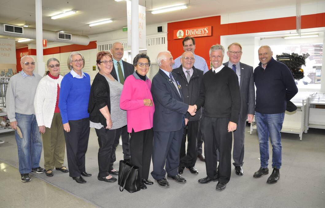 Tony and Adriana Lamarra with Dimmeys store manager and new tenant, Geoff Maguire, agents Peter Mylonas and Ed Zammit, Mayor Bob Kirk, general manager Warwick Bennett and friends inside the shop on Tuesday. The Lamarras have purchased the building.
