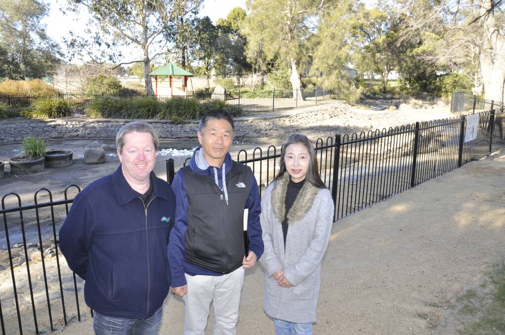 EXPERT: Japanese landscape designer Tomoki Izumi with council director of corporate and community services Brendan Hollands and interpreter Kazumi Toida at Victoria Park. Photo: Louise Thrower.