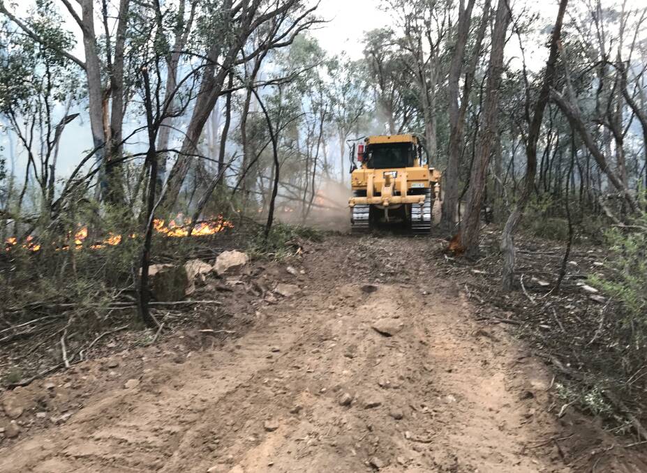 Divall's earthmovers built containment lines at the Jacqua Creek fire ground at Bungonia. Photo supplied.