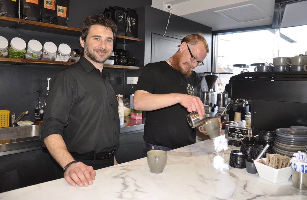Park Cafe owner/manager Laz Foinikopoulos, with barista Tom Gaskin, is happy to be back in full operation following coronavirus restrictions. Photo: Louise Thrower.