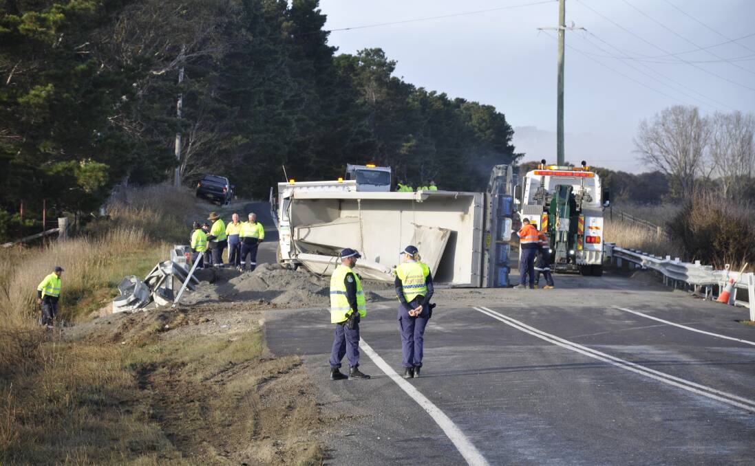 ROLLOVER: Police, council workers and a salvage team were at the scene of a truck rollover on Braidwood Road on Tuesday morning. The crash blocked the road in both directions until about 9am. Photo: Louise Thrower.