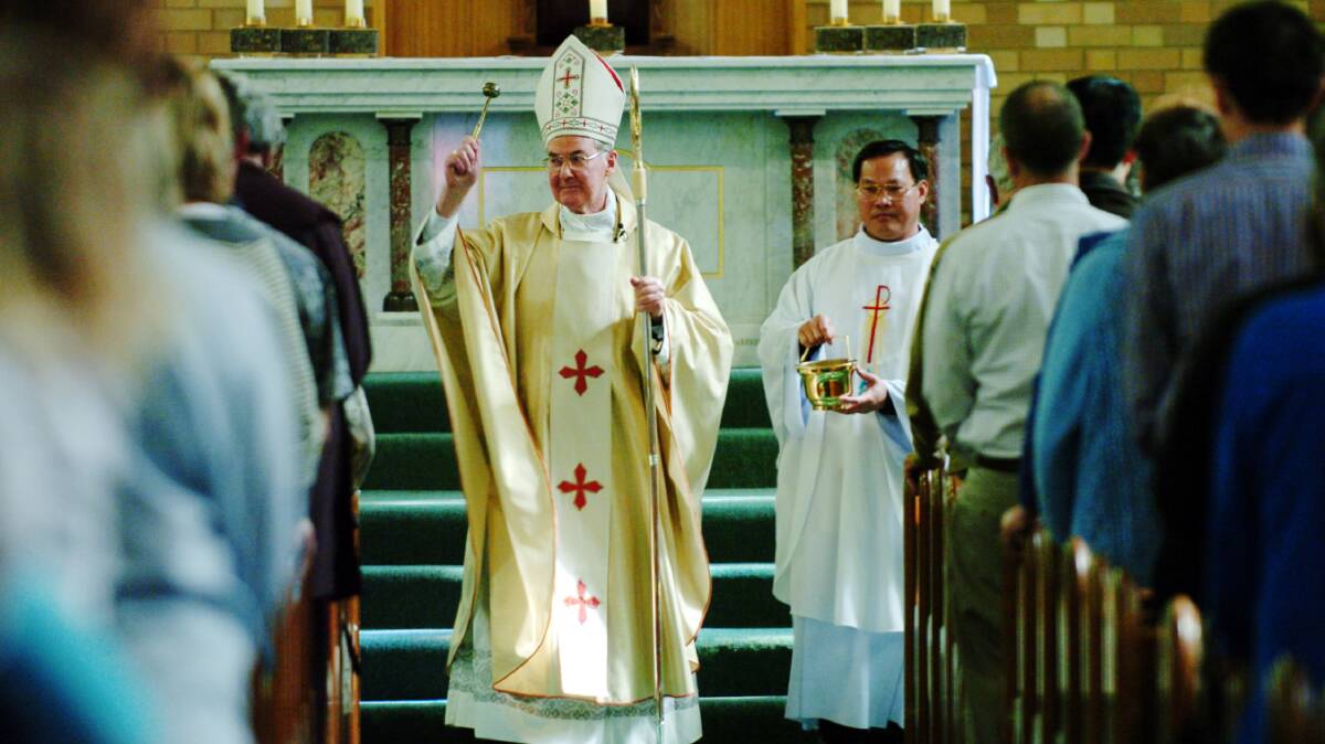 Archbishop Francis Carroll and Father Peter My sprinkling the congregation with Easter holy water at the St Christopher's Cathedral Easter Sunday Mass in 2005. Picture by Jodie Richter