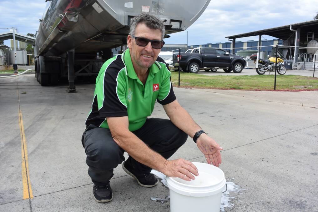 OFFERING HELP: Unicorn Cheese production manager Graeme Banister with a bucket of whey. Photo: Madeline Crittenden. 