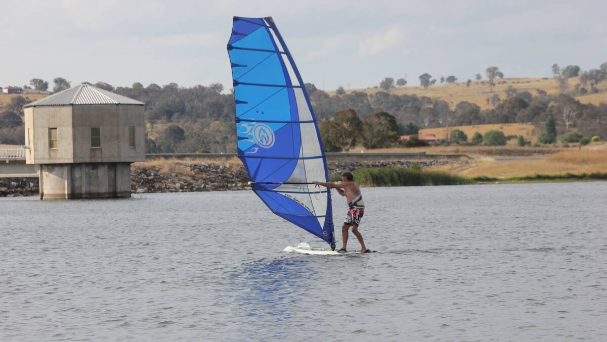 WIND CHASER: Pejar Dam was 100 per cent full n early 2018 as Stephen Lee took his windsurfer for a dance across it. The dam is about 86 pc full now. Photo David Cole