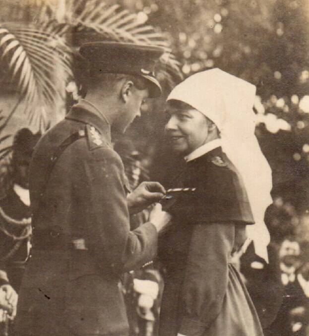service recognised: Alice Joan Twynam receiving the Royal Red Cross Medal from the future King Edward VIII in 1919.  Photo supplied.