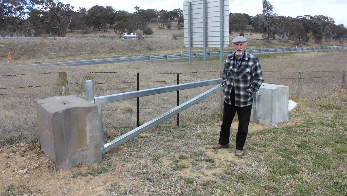 PROBLEM: Run-O-Waters Estate resident Bruce Herrett pointing out deficincies with the new emergency access gate onto the Hume Highway from Greendale Court. 