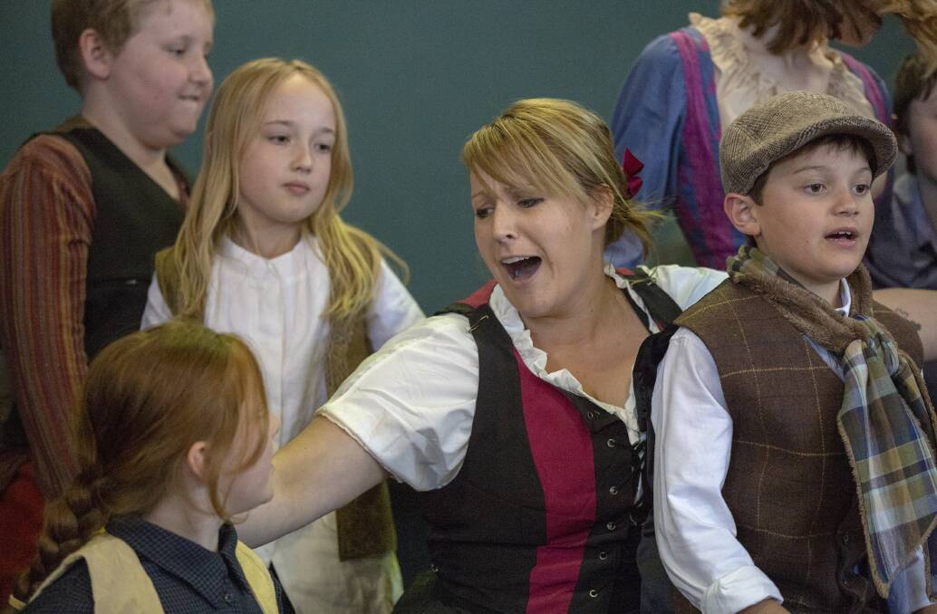 Bianca Coombs (as Nancy) and some of the children in a scene from the RHMTC production of Oliver. Photo Peter Oliver. 