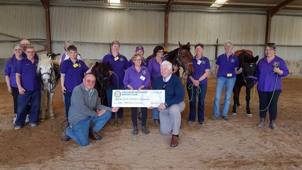 GIVING BACK: Rotary Club of Goulburn Mulwaree board members and Grant Pearce presenting a cheque to Goulburn Riding for the Disabled. Photo supplied.