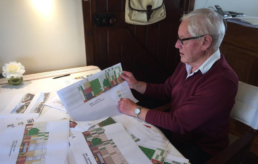 PLANS: Goulburn Heritage Group member David Penalver looking over various plans for the multi-storey car park. Photo David Cole. 