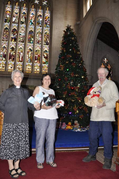 GIVING SPIRIT: St Saviours sub-dean Canon Anne Wentzel and parishioners Anna Krebs and John McCulloch at the Giving Tree in the Cathedral. 