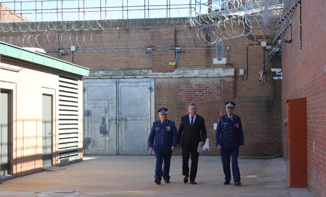 WALLS: Goulburn Jail governor Larry Bulger, Minister for Corrections Anthony Roberts and CSNSW Commissioner Peter Severin inspecting the outside of the facility. 