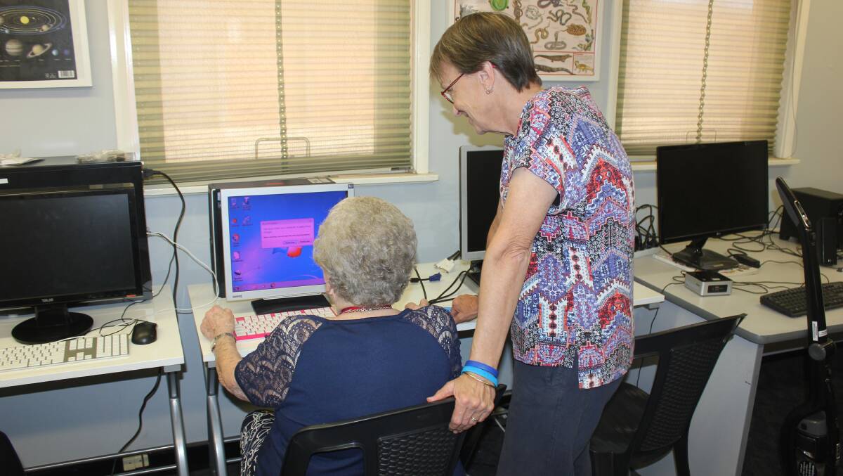 Pat Spilsbury getting a computer lesson at the U3A. 