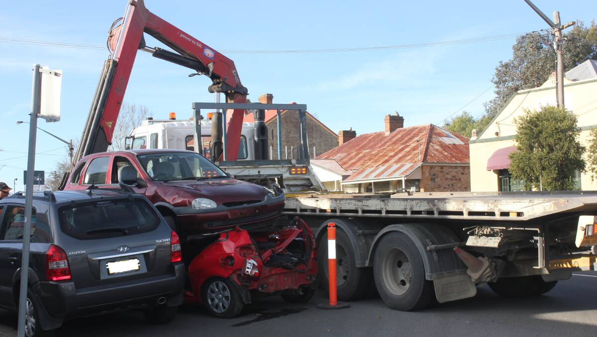 CARS ROLL OFF TRUCK: The scene on Thursday afternoon, where two cars had rolled off the back of a truck in Sloane St. Photo David Cole. 