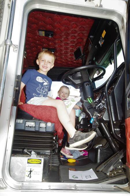 ALL ABOARD: Alexander and Savannah Widdows in one of the trucks that was in the Convoy for Kids on Saturday. Photo Darryl Fernance. 